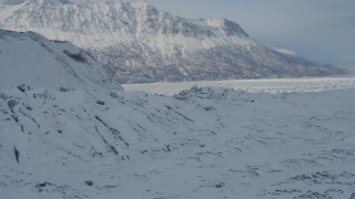 4K aerial stock footage flying toward an icy, snow covered glacial ridge, Knik Glacier, Alaska Aerial Stock Footage | AK0001_1415