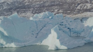 AK0001_1435 - 4K aerial stock footage orbiting a chunk of glacial ice in Inner Lake George, Alaska in snow