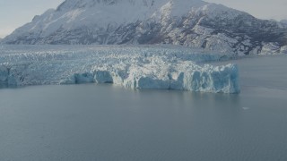 AK0001_1444 - 4K aerial stock footage flying toward edge of glacier on Inner Lake George, snow covered peak, Alaska