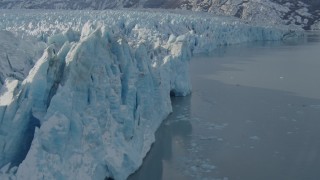 AK0001_1446 - 4K aerial stock footage flying along edge of snow covered glacier on Inner Lake George, Alaska