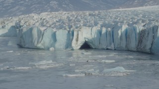 AK0001_1473 - 4K aerial stock footage flying toward edge of a snow covered glacier on Inner Lake George, Alaska