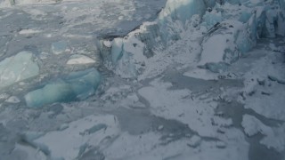 4K aerial stock footage flying over edge of snow covered glacier on Inner Lake George, Alaska Aerial Stock Footage | AK0001_1476