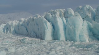 AK0001_1478 - 4K aerial stock footage flying over ice on Inner Lake George along edge of snow covered glacier, Alaska