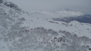 4K aerial stock footage flying along snowy slopes of Chugach Mountains, Alaska Aerial Stock Footage | AK0001_1486