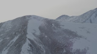 4K aerial stock footage flyby a mountain peak with light snow in the Chugach Mountains, Alaska Aerial Stock Footage | AK0001_1497