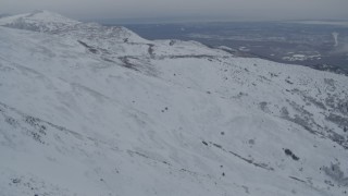 4K aerial stock footage fly over snowy mountain slopes reveal Anchorage, Chugach Mountains, Alaska Aerial Stock Footage | AK0001_1507