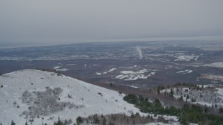 4K aerial stock footage flying over snowy slope revealing Anchorage, Chugach Mountains, Alaska Aerial Stock Footage | AK0001_1508