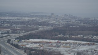 4K aerial stock footage snow covered Downtown Anchorage, flying behind plume of steam, Alaska Aerial Stock Footage | AK0001_1514