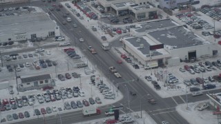 4K aerial stock footage snow covered auto dealerships on East 5th Avenue, Downtown Anchorage, Alaska Aerial Stock Footage | AK0001_1521