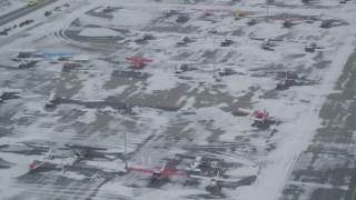 4K aerial stock footage descend toward parked airplanes at snowy Merrill Field, Anchorage, Alaska Aerial Stock Footage | AK0001_1529