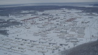 AK0001_1530 - 4K aerial stock footage snow covered Fort Richardson residential neighborhoods, Anchorage, Alaska