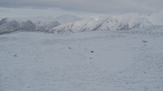 4K aerial stock footage fly over snowy slope, mountain range, wooded valley, Chugach Mountains, Alaska Aerial Stock Footage | AK0001_1540