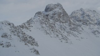 4K aerial stock footage flying toward rocky, snowy mountain summits in Chugach Mountains, Alaska Aerial Stock Footage | AK0001_1558