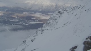 AK0001_1566 - 4K aerial stock footage the town of Butte seen from snowy Chugach Mountains, Alaska