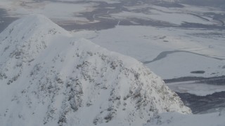 4K aerial stock footage flying through clouds toward snowy mountain ridge, Chugach Mountains, Alaska Aerial Stock Footage | AK0001_1570