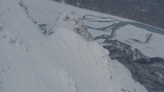 4K aerial stock footage rounding snowy peak revealing Knik River Valley, Chugach Mountains, Alaska Aerial Stock Footage | AK0001_1571