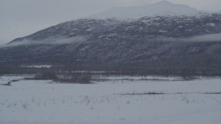 4K aerial stock footage flying by snow covered Chugach Mountains, Knik River Valley, Alaska Aerial Stock Footage | AK0001_1591