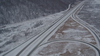 4K aerial stock footage tilting up the length of snow covered Glenn Highway, Anchorage, Alaska Aerial Stock Footage | AK0001_1613