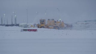 AK0001_1650 - 4K aerial stock footage buildings at Merrill Field, reveal passing snow plow, Anchorage, Alaska, twilight