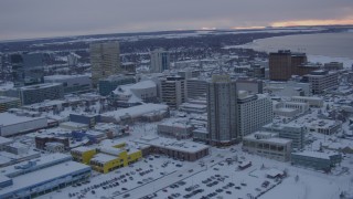 AK0001_1653 - 4K aerial stock footage fly over snowy East Loop Road Bridge, Downtown Anchorage, Alaska, twilight