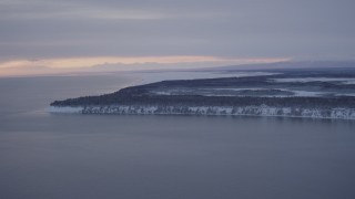 AK0001_1662 - 4K aerial stock footage flying toward snowy Point MacKenzie at twilight, Alaska