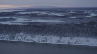 4K aerial stock footage flying over snow covered woods of Point MacKenzie at twilight, Alaska Aerial Stock Footage | AK0001_1663