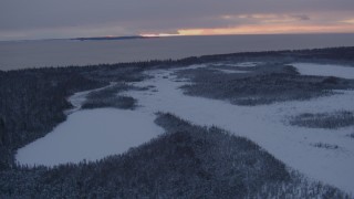 4K aerial stock footage Fire Island seen from snow covered Point MacKenzie at twilight, Alaska Aerial Stock Footage | AK0001_1664