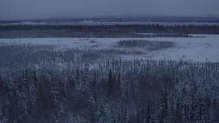 4K aerial stock footage a view of Downtown Anchorage seen from snowy Point MacKenzie at twilight, Alaska Aerial Stock Footage | AK0001_1680