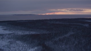 4K aerial stock footage twilight lit clouds seen from snow covered Point MacKenzie, Alaska Aerial Stock Footage | AK0001_1684