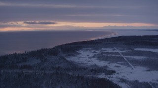 AK0001_1688 - 4K aerial stock footage twilight lit clouds, forests on snow covered Point MacKenzie, Alaska