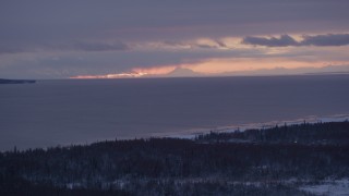 4K aerial stock footage twilight lit clouds over Cook Inlet seen from snow covered Point MacKenzie, Alaska Aerial Stock Footage | AK0001_1689