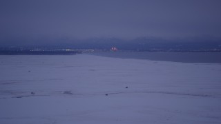 4K aerial stock footage Downtown Anchorage seen from snowy Point MacKenzie, Alaska, twilight Aerial Stock Footage | AK0001_1713