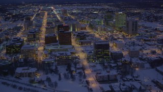 4K aerial stock footage fly over icy shore of Cook Inlet and snowy Downtown Anchorage, Alaska, night Aerial Stock Footage | AK0001_1721