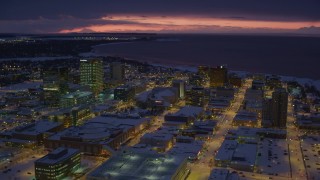 4K aerial stock footage flying over snow covered Downtown Anchorage at night, Alaska Aerial Stock Footage | AK0001_1726