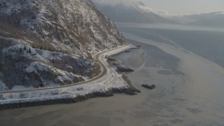 AK0001_1741 - 4K aerial stock footage approaching Seward Highway on the snowy shore of the Turnagain Arm, Alaska