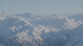 4K aerial stock footage snow covered ranges in Chugach Mountains with low clouds, Alaska Aerial Stock Footage | AK0001_1756