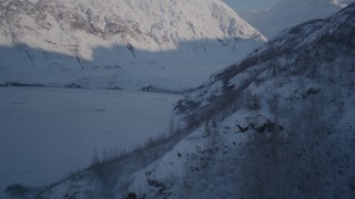 4K aerial stock footage rounding a slope toward a snow covered glacier, Chugach Mountains, Alaska Aerial Stock Footage | AK0001_1776