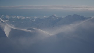 4K aerial stock footage flying over snowy, windblown mountain ridge in Chugach Mountains, Alaska Aerial Stock Footage | AK0001_1778