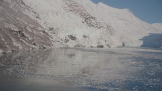 4K aerial stock footage flying low over Harriman Fjord toward snow covered glaciers, Alaska Aerial Stock Footage | AK0001_1794