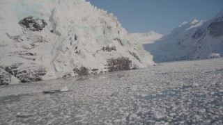 4K aerial stock footage flying low over icy surface of Harriman Fjord toward snowy glacier, Alaska Aerial Stock Footage | AK0001_1795