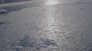 AK0001_1796 - 4K aerial stock footage panning across icy, snowy surface of Harriman Fjord, Alaska