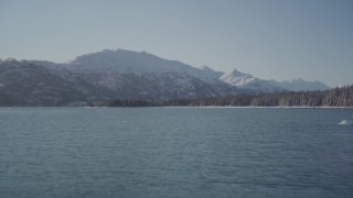 4K aerial stock footage flying low over surface of water in Harriman Fjord, Alaska in snow Aerial Stock Footage | AK0001_1830