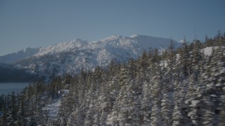 AK0001_1867 - 4K aerial stock footage flying along snowy wooded shore of Port Wells, Alaska