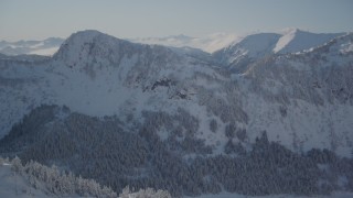 AK0001_1875 - 4K aerial stock footage flying over snowy ridge revealing Chugach Mountains, Port Wells, Alaska