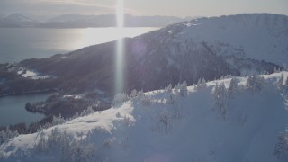 AK0001_1877 - 4K aerial stock footage pan across a snowy mountain ridge of the Chugach Mountains, Port Wells, Alaska