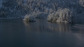 AK0001_1884 - 4K aerial stock footage flying low over Port Wells and between two snowy islands, Alaska