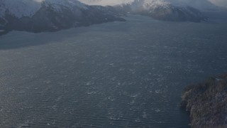 4K aerial stock footage windblown water of Passage Canal beside snowy shore, Alaska, tilt to Chugach Mountains Aerial Stock Footage | AK0001_1905