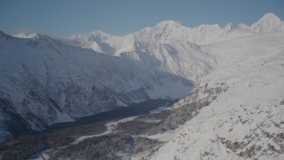 4K aerial stock footage rounding snowy slopes, revealing river valley, Chugach Mountains, Alaska Aerial Stock Footage | AK0001_1906