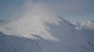 4K aerial stock footage flying over snow packed ground toward snowy peak, Chugach Mountains, Alaska Aerial Stock Footage | AK0001_1913