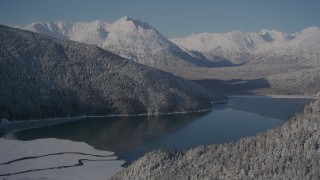 AK0001_1922 - 4K aerial stock footage descend toward Carmen Lake, snowy Chugach Mountains, Alaska